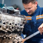 a man repairing a diesel engine